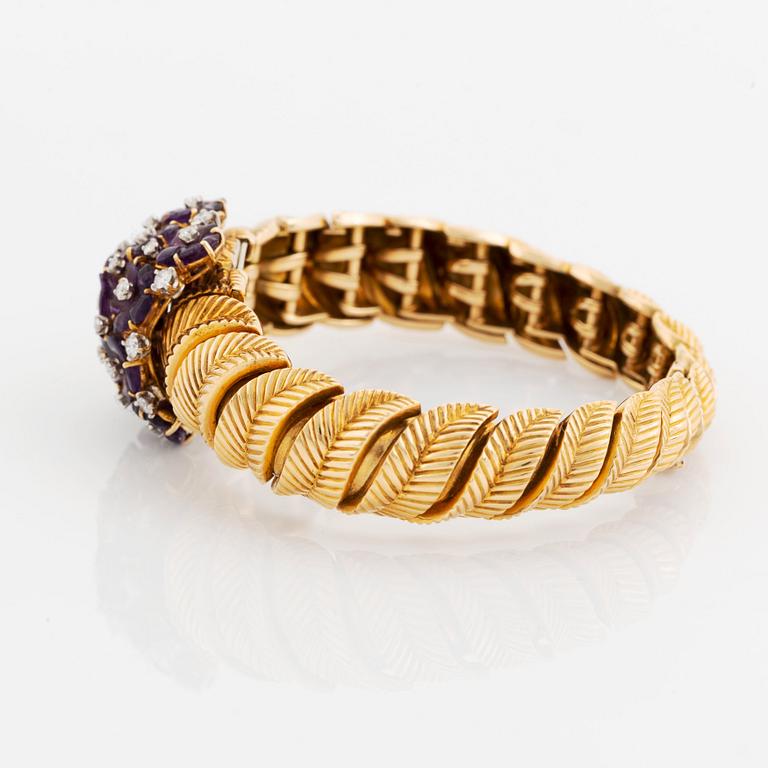 A Gübelin bracelet/wristwatch in 18K gold set with amethysts and round brilliant-cut diamonds.