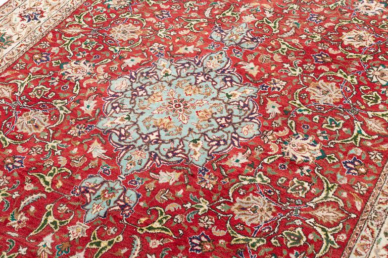 A carpet, Tabriz old, signed, approximately 294 x 208 cm.