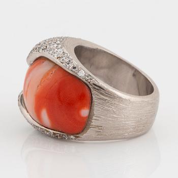 A Paul Binder ring in 18K white gold set with coral and round brillliant-cut diamonds.