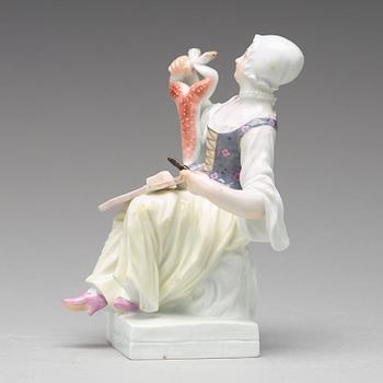 A Meissen figure of a woman preparing a rabbit, second half of 19th Century.