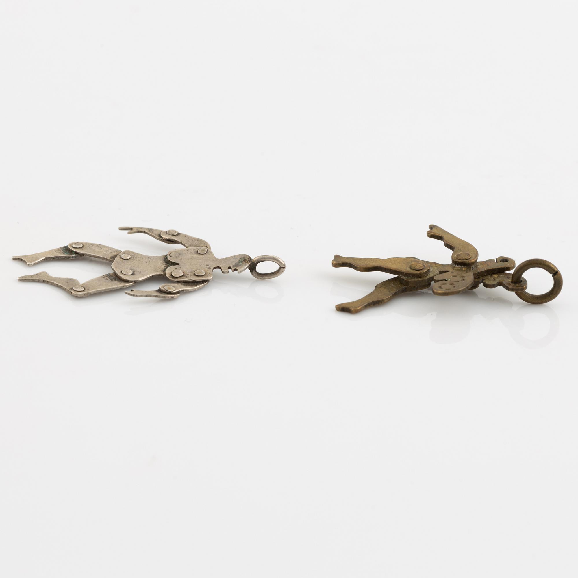 Two pendants, silver and yellow metal.