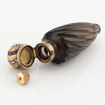 A smoky quartz flacon with a 14K gold lid mounted with rubies and rose-cut diamonds, C.E. Bolin, Moscow, 1890s.