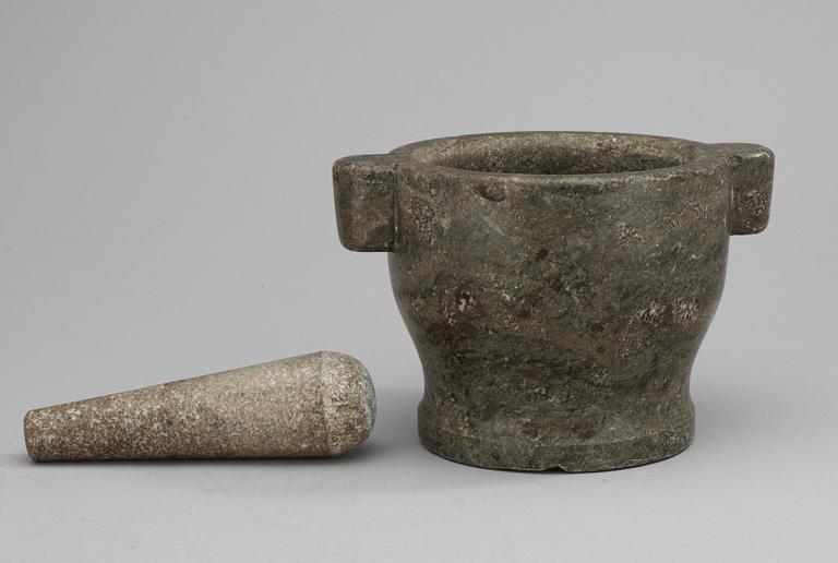 A marble mortar with pestle.