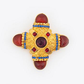 Gianni Versace, a gold tone and glass stone brooch.