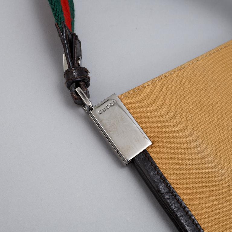 Gucci, a canvas handbag.