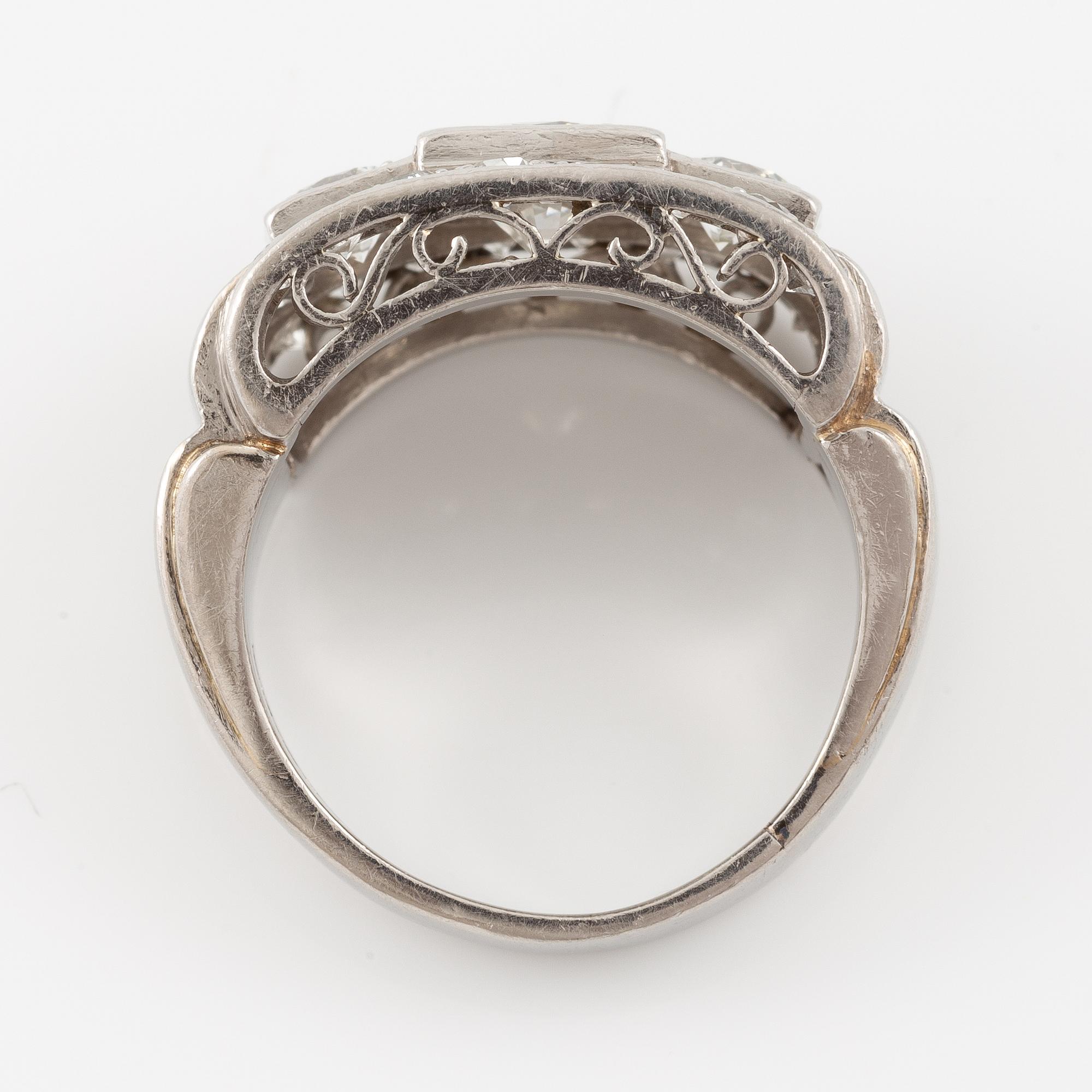 A platinum ring set with round brilliant and old-cut diamonds.