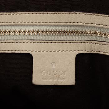 Gucci, a cream leather handbag.