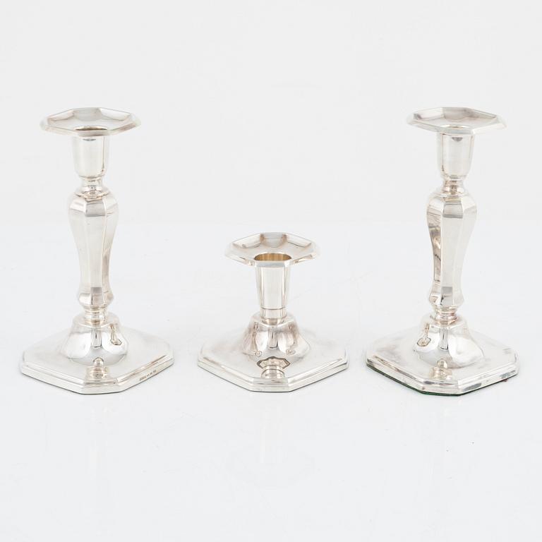 A pair of silver candlesticks, MGAB, Uppsala, 1985 and a silver candlestick, MEMA, Lidköping, 1987.