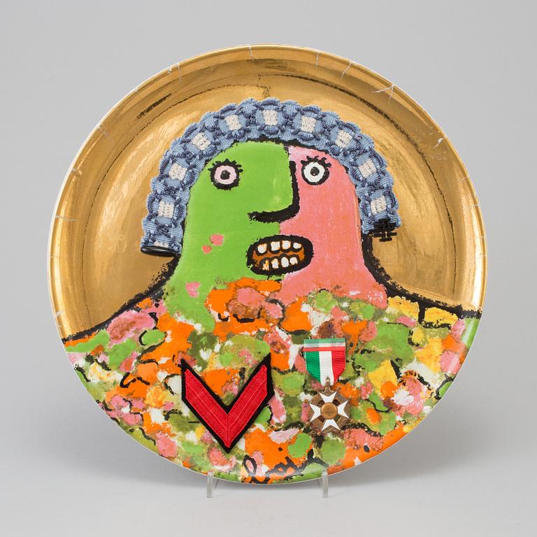 An Enrico Baj porcelain plate with garter and medals, "L'Ultimo dei Generali", Ceramica Franco Pozzi, numbered 650/3000.