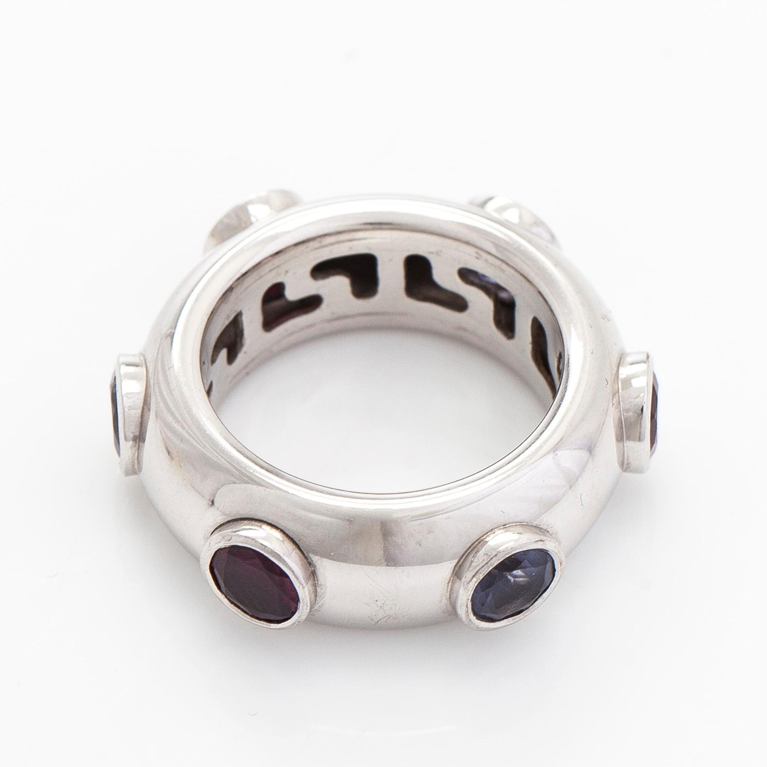 An 18K white gold ring with garnets and cordierites.