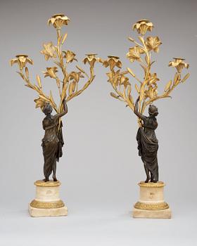 A pair of French Louis XVI-style 19th century three-light candelabra.