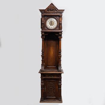 A long-case clock, late 19th century.
