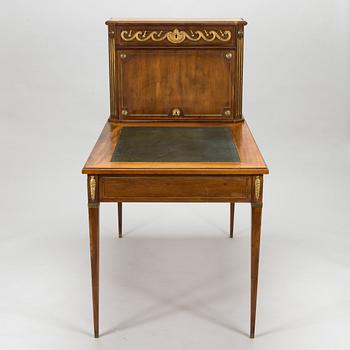 A 20th-century Louis XVI style mahogany veneered writing desk.