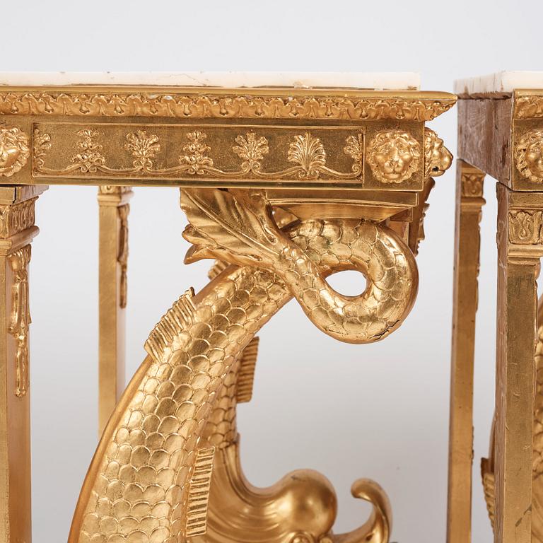 A pair of Swedish Empire carved and giltwood console tables, first half of the 19th century.