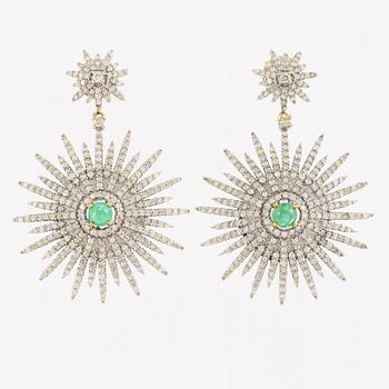 Earrings with cabochon-cut emeralds and diamonds.