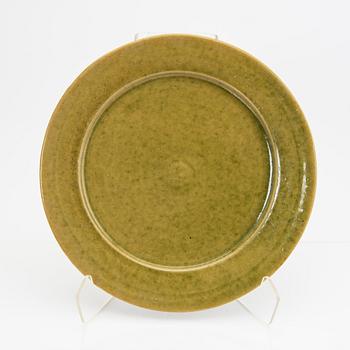 Signe Persson-Melin, a set of nine 1950s kopper glazed stoneware plates.