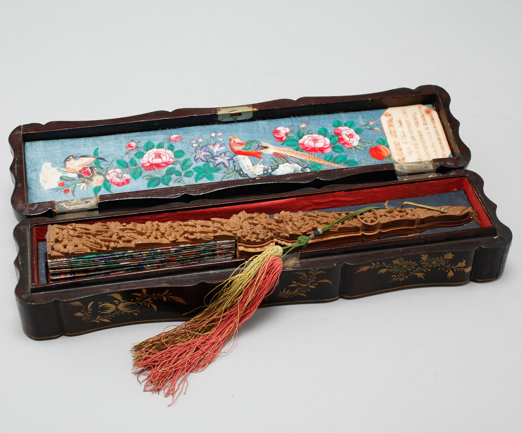 A chinese fan in a black lacquered box, Qing dynasty (1644-1912).