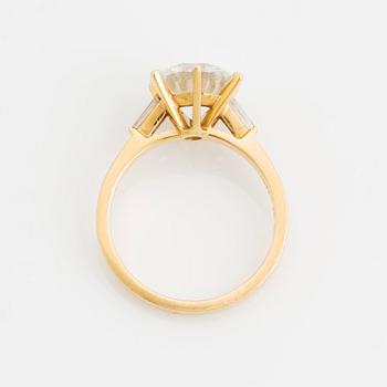 An 18K gold ring set with a round brilliant-cut diamond weight 3.30 cts quality E vs2.