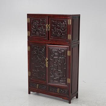 A small Chinese stained wood two part cabinet, 1900s.