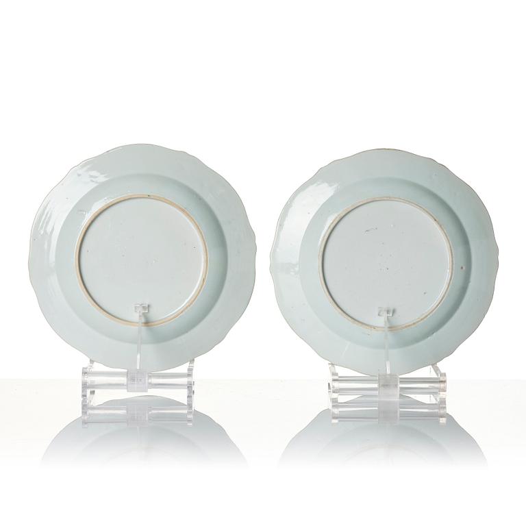 A pair of Chinese famille rose porcelain 'double peacock' plates, Qing dynasty, Qianlong (1736-95).