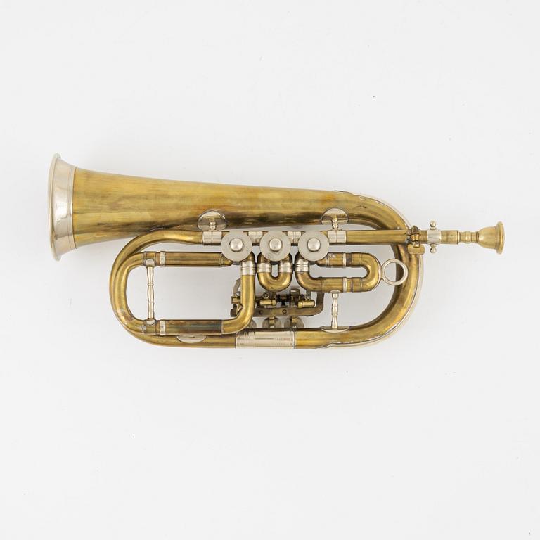 A brass cornet, marked with a crown.