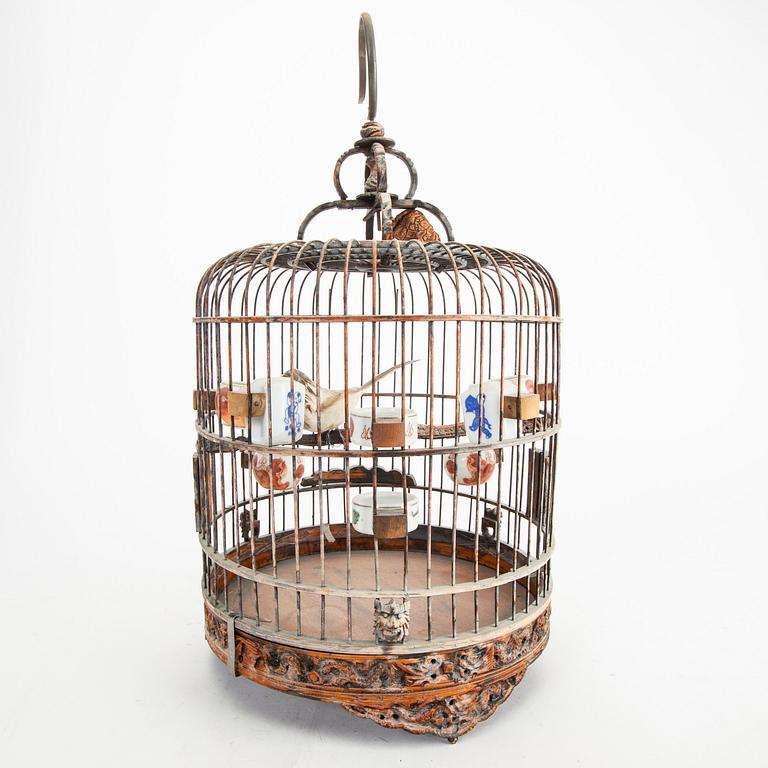 A Chinese bird cage with bird feeders, 20th Century.