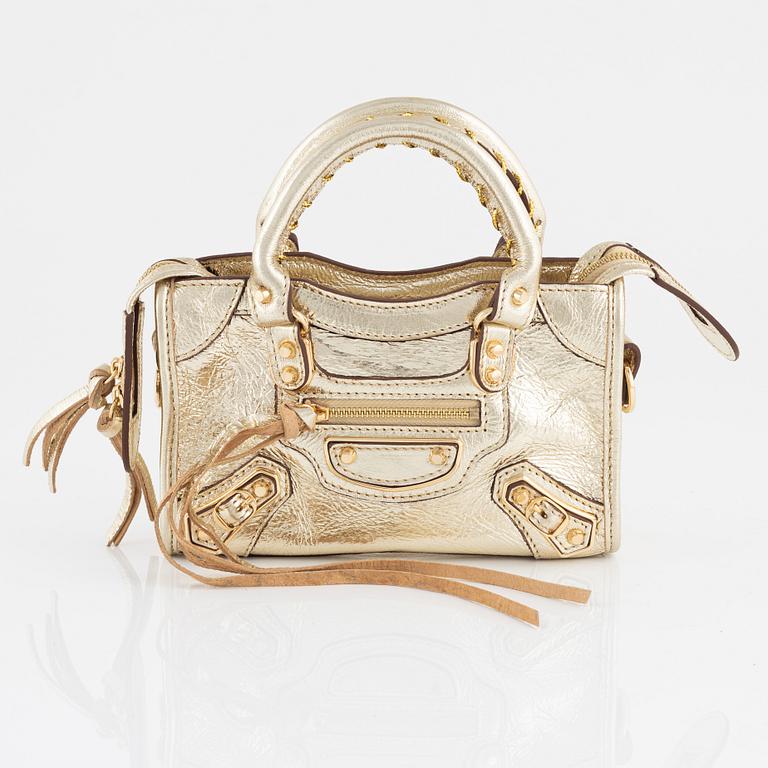 Balenciaga, a gold leather 'Classic City Mini Bag'.