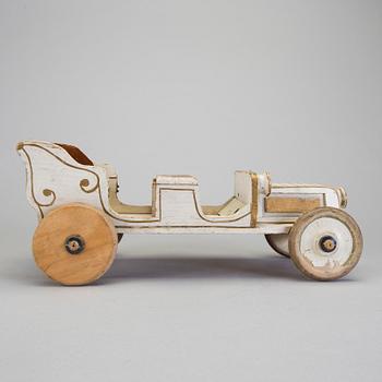 A painted wooden toy car c. 1910.