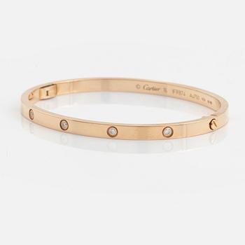 A Cartier "Love" bracelet small model in 18K rose gold with ten round brilliant-cut diamonds.