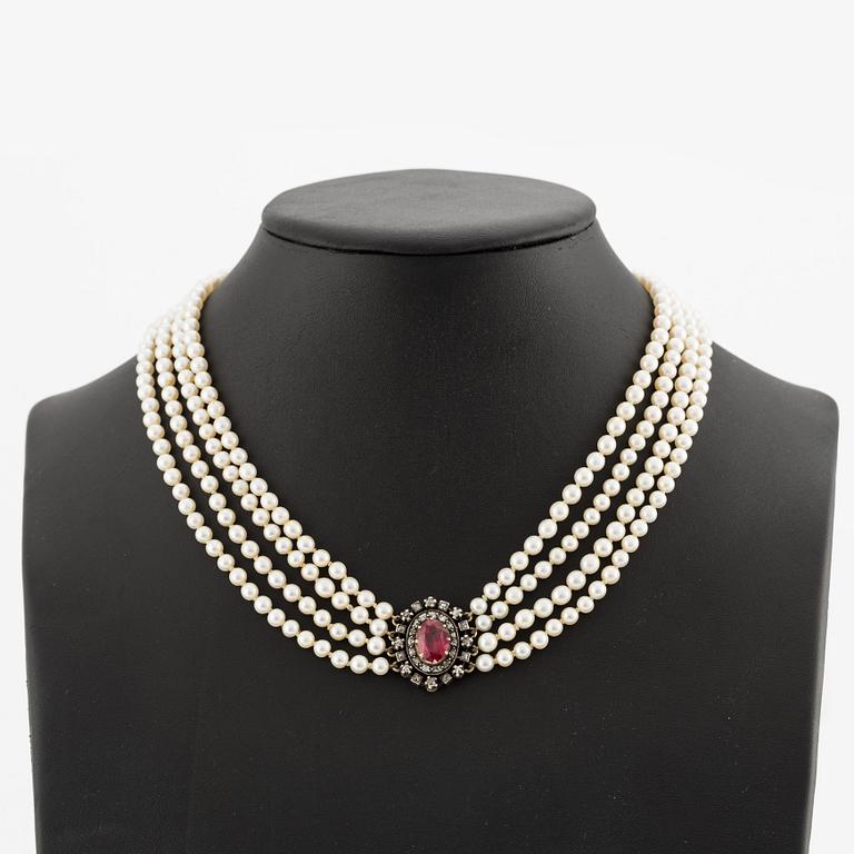 Necklace, four-stranded with cultured pearls, clasp in gold and silver with old-cut diamonds and synthetic stone.