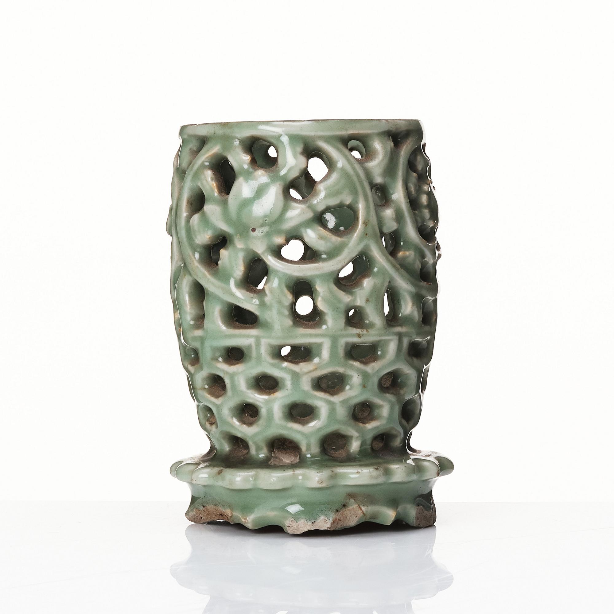 A reticulated lonquan celadon vase/candle holder, Ming dynasty (1368-1644).