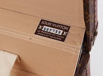 A monogram canvas suitcase by Louis Vuitton.