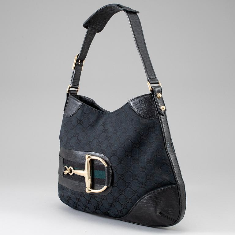 GUCCI, a black canvas and leather bag.