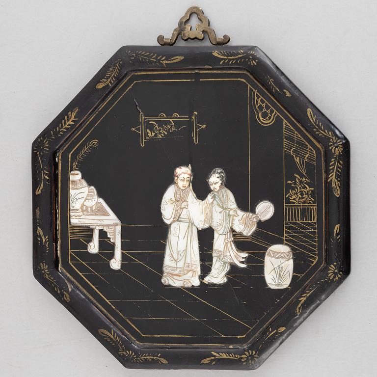 Four black-lacquered wall decorations, China, around 1900.