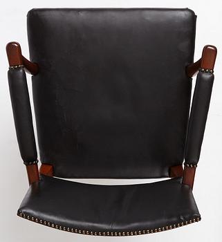 Josef Frank, a mahogany and black leather swivel chair, modified version of model 695, Svenskt Tenn, ca 1956-1957.