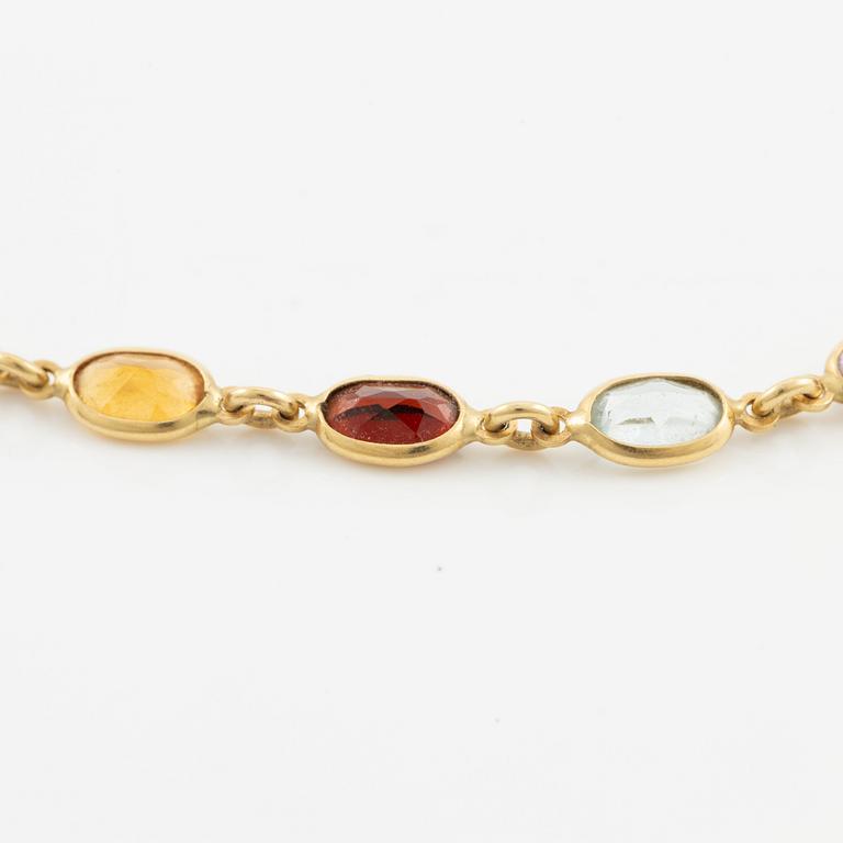 Necklace in 18K gold set with, among other stones, peridot, topaz, citrine, and amethyst.