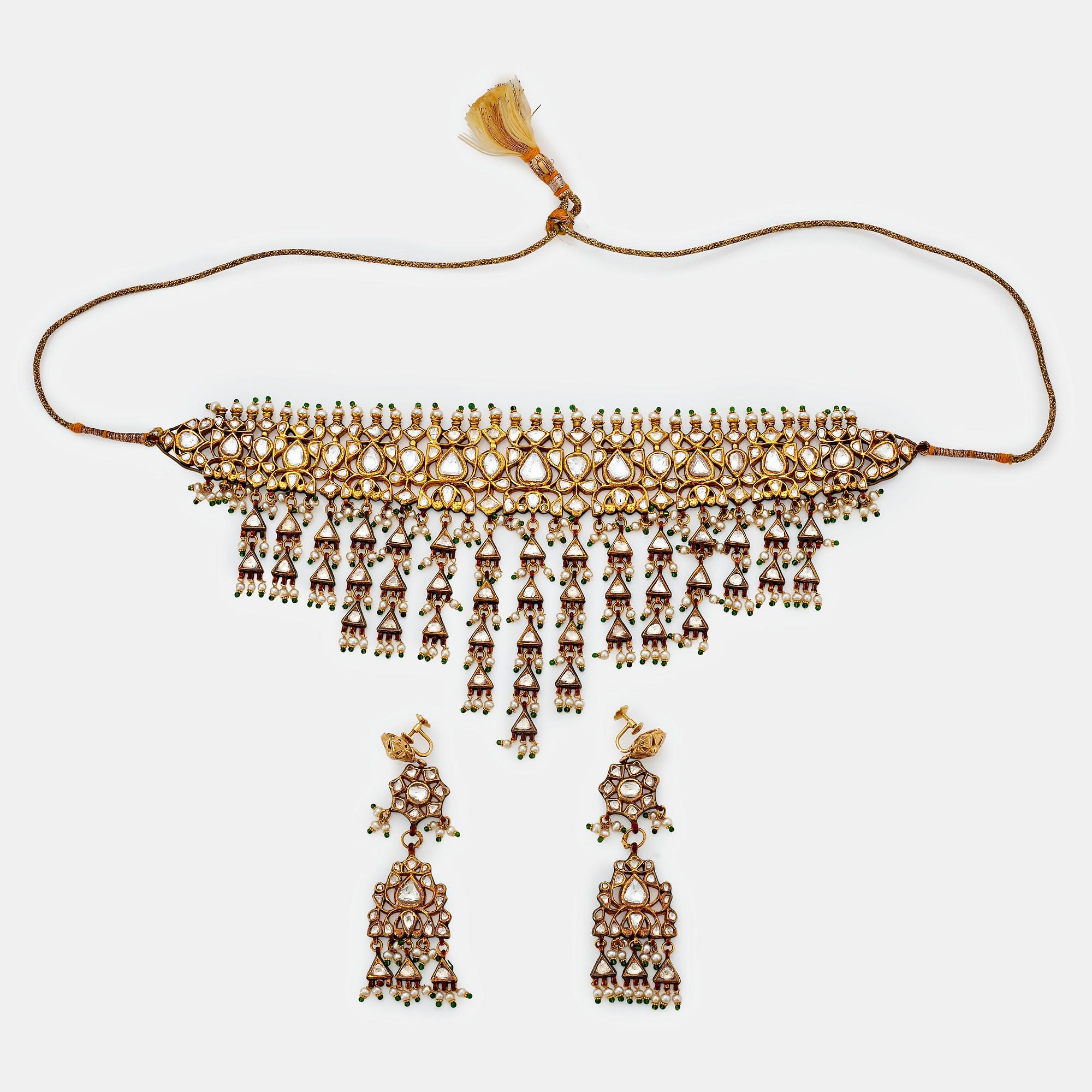 An Indian demi parure comprising a necklace and a pair of earrings.