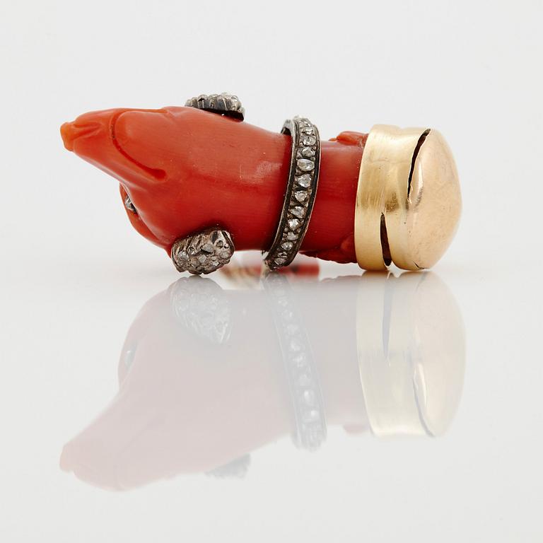 A 14 K gold and silver pendant with carved coral set with rose-cut diamonds.