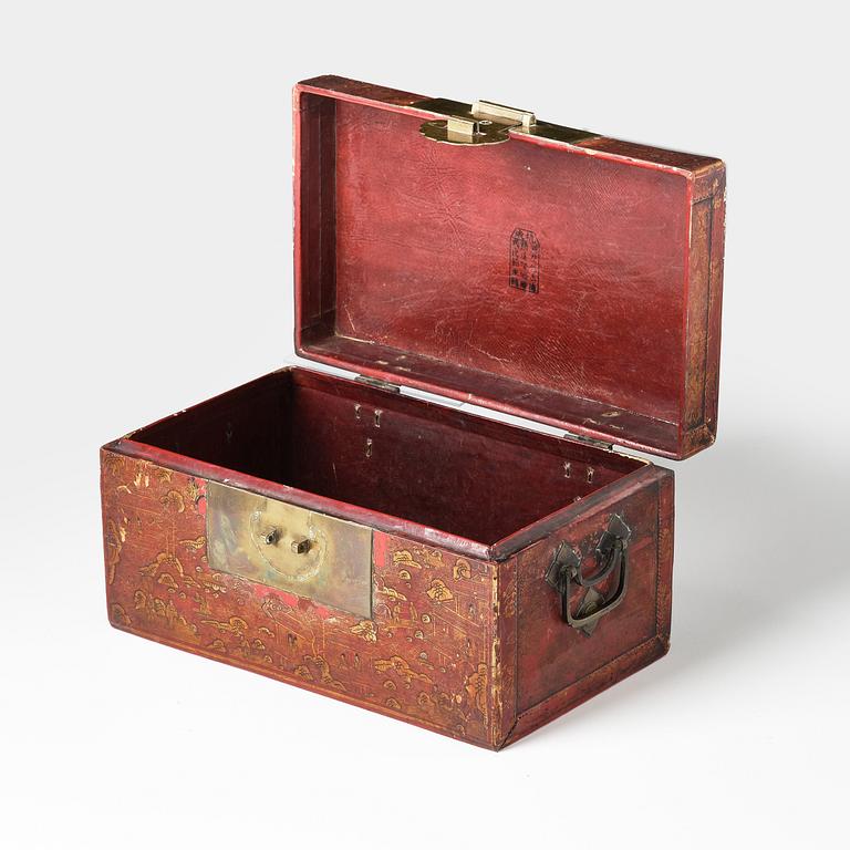 A set of two gilt decorated leather clad wooden chests, late Qing dynasty.