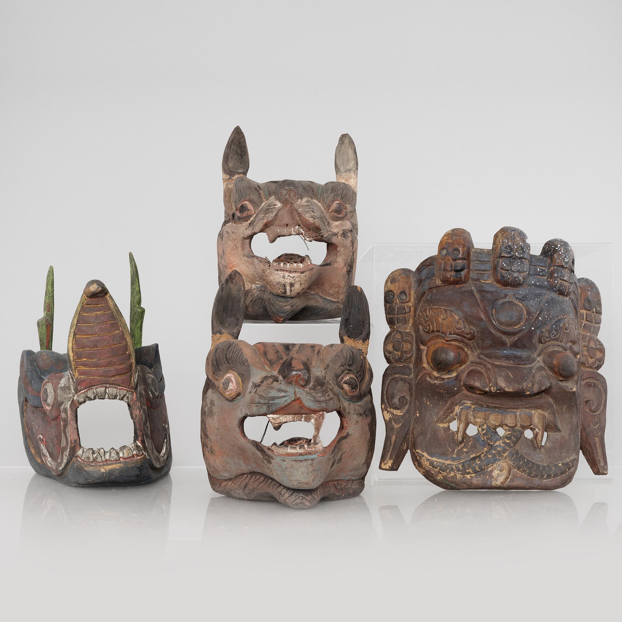 Four Tibetan/South East Asian wooden decorations, 20th century.