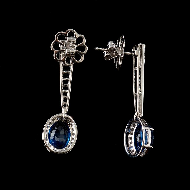 A pair of sapphire and diamond earrings. Sapphire total carat weight 5.63 cts, diamond total carat weight 0.62 ct.