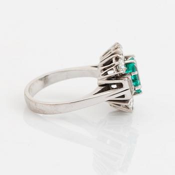 An 18K white gold ring set with a step-cut emerald.