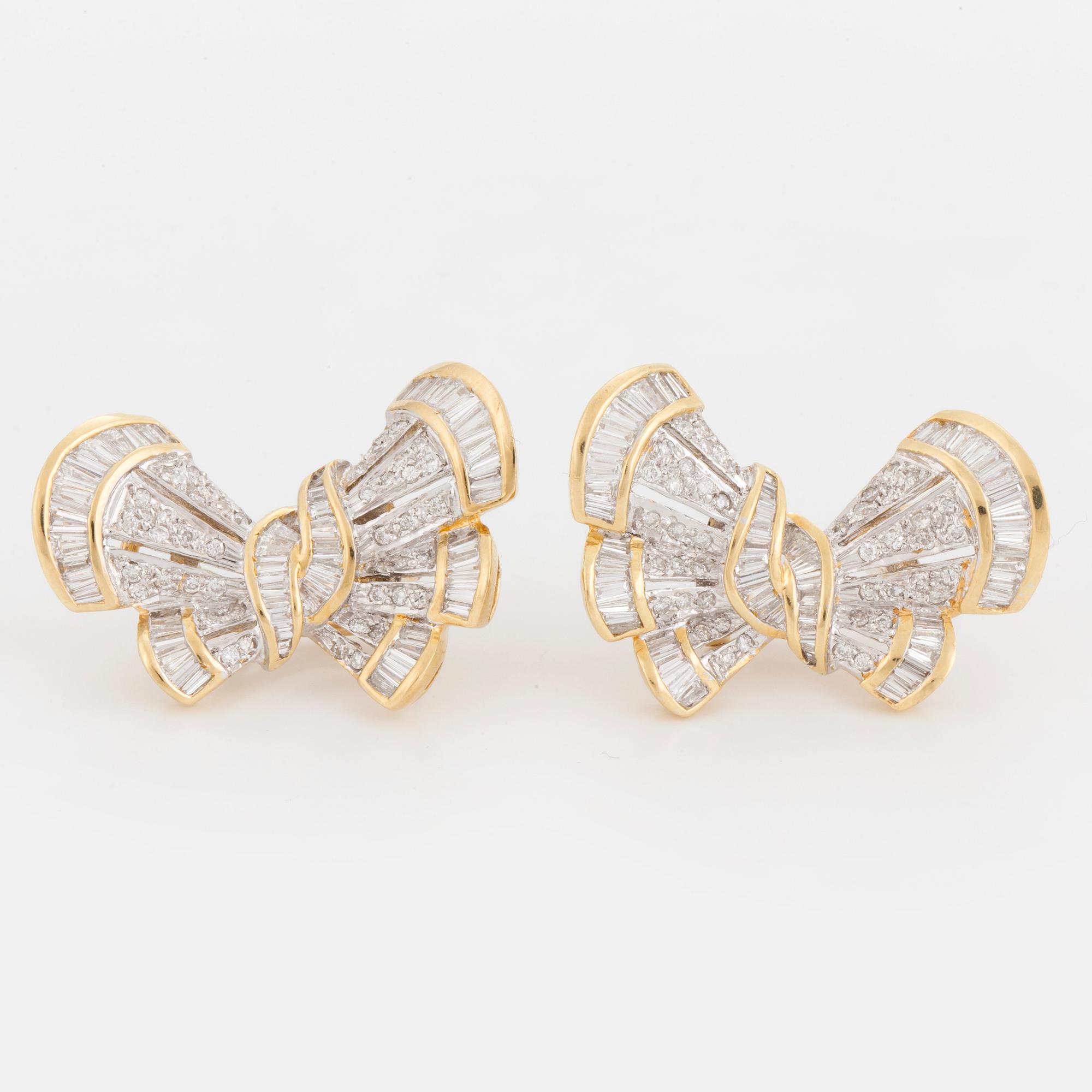 A pair of earrings in the shape of bows set with round, brilliant and tapered, baguette-cut diamonds.