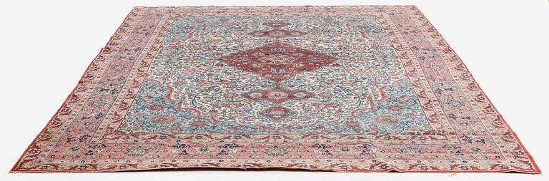 A semi-antique Qum carpet. Central Persia, c. 345 x 258 cm.