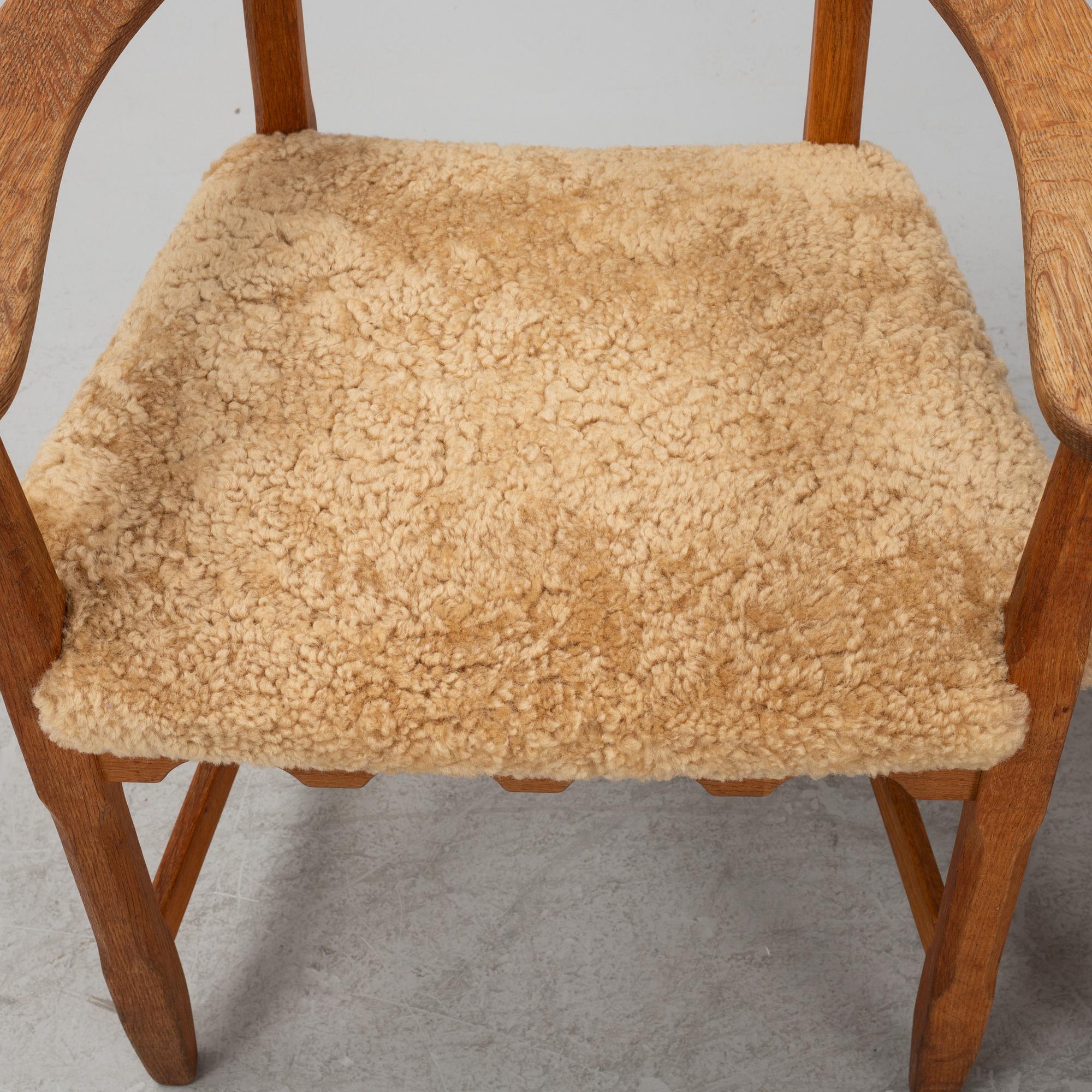 Henning Kjærnulf, a pair of oak 'Razorblade' armchairs with new sheepskin upholstery, from EGK, Demark, 1960s.
