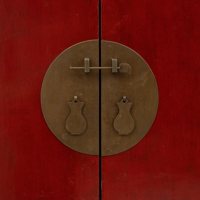 A red-lacquered cabinet, China, 20th century.