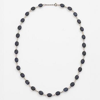 18K white gold necklace with dark sapphires.