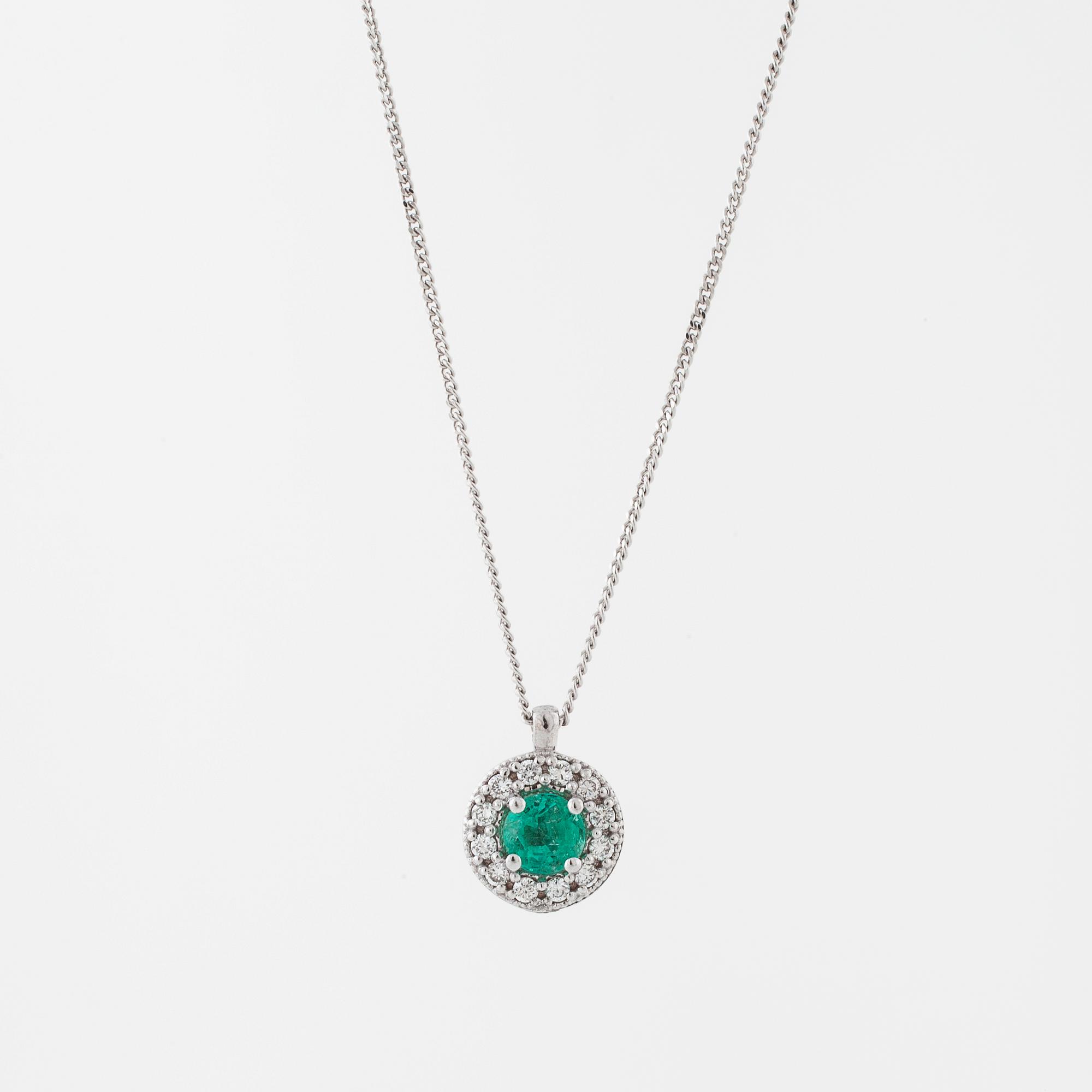An emerald and brilliant cut diamond pendant.