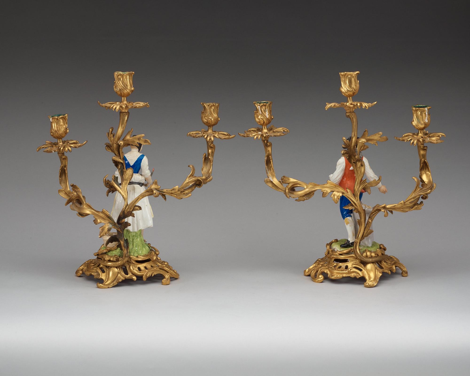 A pair of bronze candelabra with porcelain figures, French/English, second half of 19th Century.