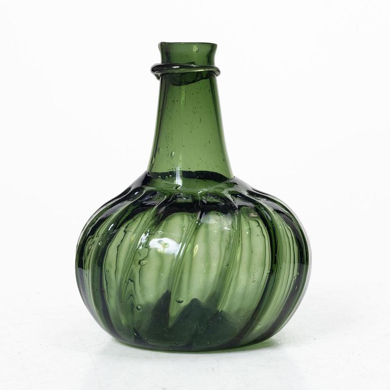 A green twisted glass bottle, 18th century.